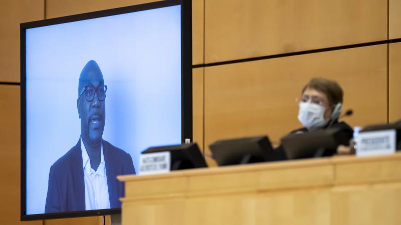 Philonise Floyd speaks via video to the U.N. Human Rights Council in Geneva on Wednesday, weeks after the killing of his brother George incited widespread protests against police brutality. U.N. human rights chief Michelle Bachelet looks on behind her fac Philonise Floyd speaks via video to the U.N. Human Rights Council in Geneva on Wednesday, weeks after the killing of his brother George incited widespread protests against police brutality. U.N. human rights chief Michelle Bachelet looks on behind her fac