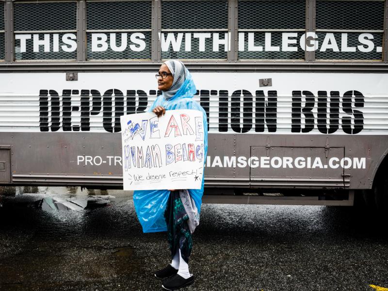 Amina Osman protests Georgia state Sen. Michael Williams's "Deportation Bus" that reads "Fill this bus with illegals." She has been a resident of Clarkston, Ga. for nine years and is a refugee from Somalia. Amina Osman protests Georgia state Sen. Michael Williams's "Deportation Bus" that reads "Fill this bus with illegals." She has been a resident of Clarkston, Ga. for nine years and is a refugee from Somalia.