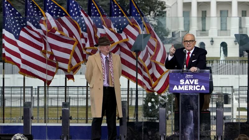 John Eastman, attorney for former President Donald Trump, stands at left as Rudy Giuliani speaks in Washington at a rally in support of Trump. John Eastman, attorney for former President Donald Trump, stands at left as Rudy Giuliani speaks in Washington at a rally in support of Trump.