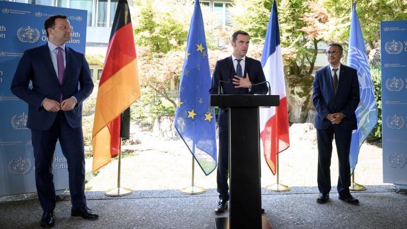 French Health and Solidarity Minister Olivier Veran (center), flanked by German Health Minister Jens Spahn (left) and World Health Organization Director-General Tedros Adhanom Ghebreyesus (right), speaks during a news conference at the WHO headquarters in French Health and Solidarity Minister Olivier Veran (center), flanked by German Health Minister Jens Spahn (left) and World Health Organization Director-General Tedros Adhanom Ghebreyesus (right), speaks during a news conference at the WHO headquarters in