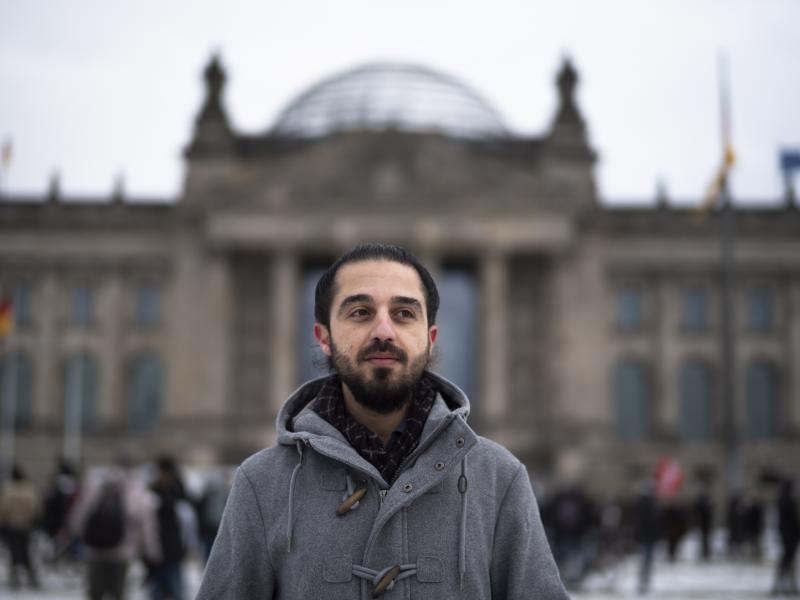 Tareq Alaows stands in front of the Bundestag, Germany's parliament, in Berlin. Alaows came to Germany as an asylum-seeker from Syria in 2015. He launched a campaign to run in Germany's federal election in September for the Green Party but recently withdr Tareq Alaows stands in front of the Bundestag, Germany's parliament, in Berlin. Alaows came to Germany as an asylum-seeker from Syria in 2015. He launched a campaign to run in Germany's federal election in September for the Green Party but recently withdr