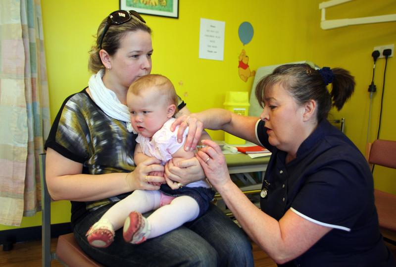 Helen Down holds her 14-month-old daughter, Amelia, for an MMR shot in Swansea, Wales, April 2013. The vaccination was in response to a measles outbreak. Helen Down holds her 14-month-old daughter, Amelia, for an MMR shot in Swansea, Wales, April 2013. The vaccination was in response to a measles outbreak.