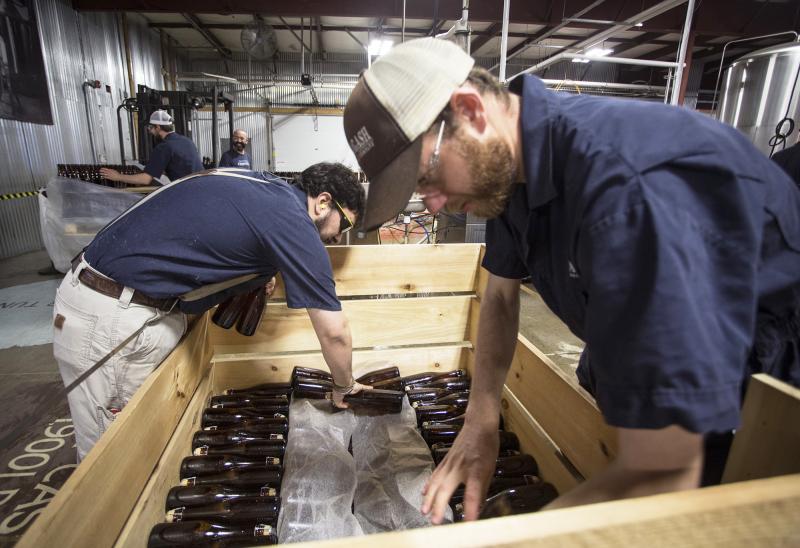 Allagash employees Salim Raal, left, and Brendan McKay stack bottles of Golden Brett, a limited release beer fermented with a house strain of Brettanomyces yeast. The Maine brewery recently installed solar panels as part of its sustainability initiatives. Allagash employees Salim Raal, left, and Brendan McKay stack bottles of Golden Brett, a limited release beer fermented with a house strain of Brettanomyces yeast. The Maine brewery recently installed solar panels as part of its sustainability initiatives.