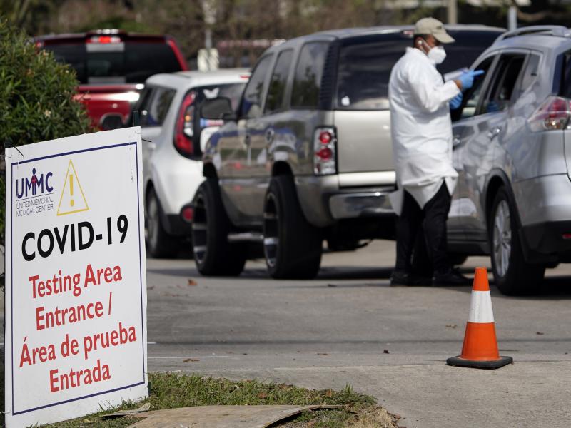 A healthcare worker processes people in line at a United Memorial Medical Center COVID-19 testing site on Nov. 19, in Houston. Texas is rushing thousands of additional medical staff to overworked hospitals as the number of hospitalized COVID-19 patients i A healthcare worker processes people in line at a United Memorial Medical Center COVID-19 testing site on Nov. 19, in Houston. Texas is rushing thousands of additional medical staff to overworked hospitals as the number of hospitalized COVID-19 patients i