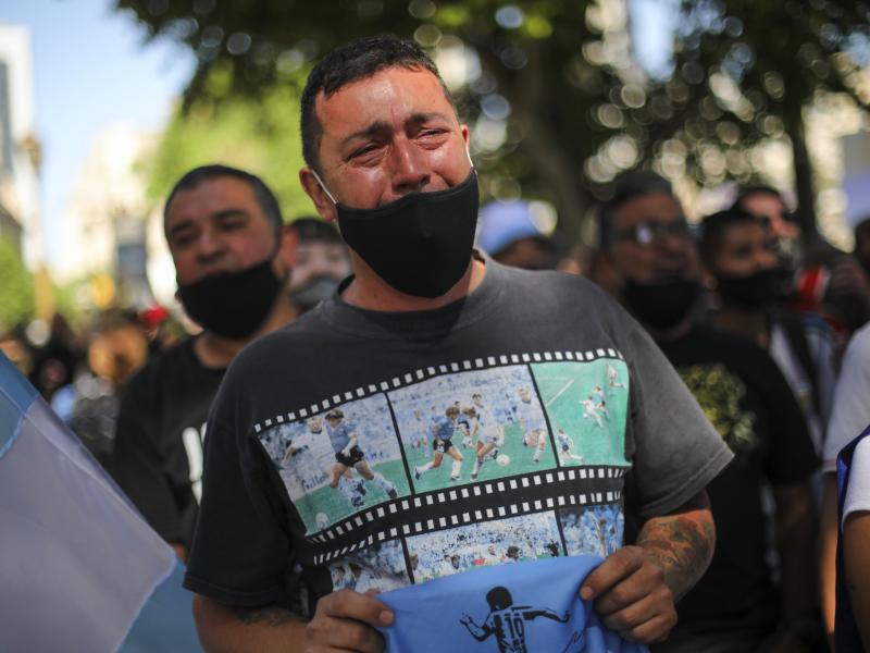 A man cries as he waits in a line outside the presidential palace to pay his final respects to Diego Maradona, in Buenos Aires on Thursday. A man cries as he waits in a line outside the presidential palace to pay his final respects to Diego Maradona, in Buenos Aires on Thursday.