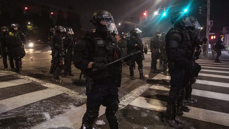Police stand guard as protesters take to the streets on Sept. 4 in Portland, Ore. Police stand guard as protesters take to the streets on Sept. 4 in Portland, Ore.