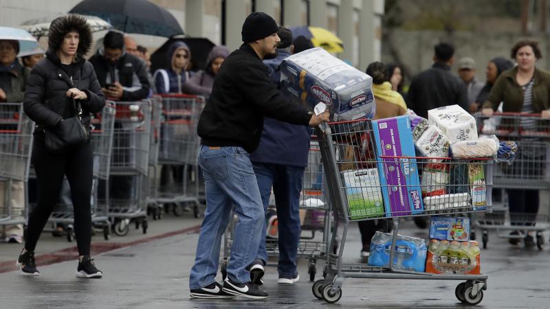 Costco customers roll groceries to their cars as others wait to enter the store on Saturday, March 14, 2020, in San Leandro, Calif. Costco customers roll groceries to their cars as others wait to enter the store on Saturday, March 14, 2020, in San Leandro, Calif.