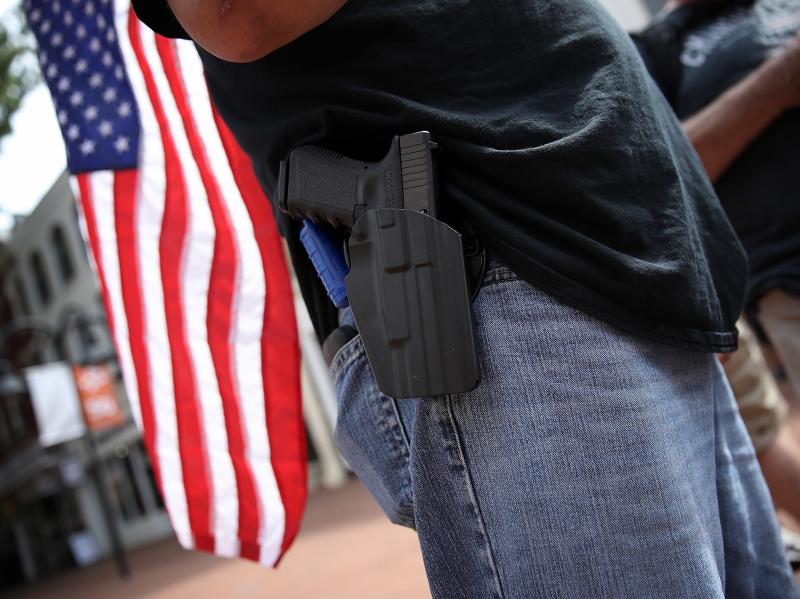 A protester wears a pistol in Charlottesville, Va., on Saturday. The ACLU says it will consider the potential for violence when evaluating whether to represent potential clients. A protester wears a pistol in Charlottesville, Va., on Saturday. The ACLU says it will consider the potential for violence when evaluating whether to represent potential clients.