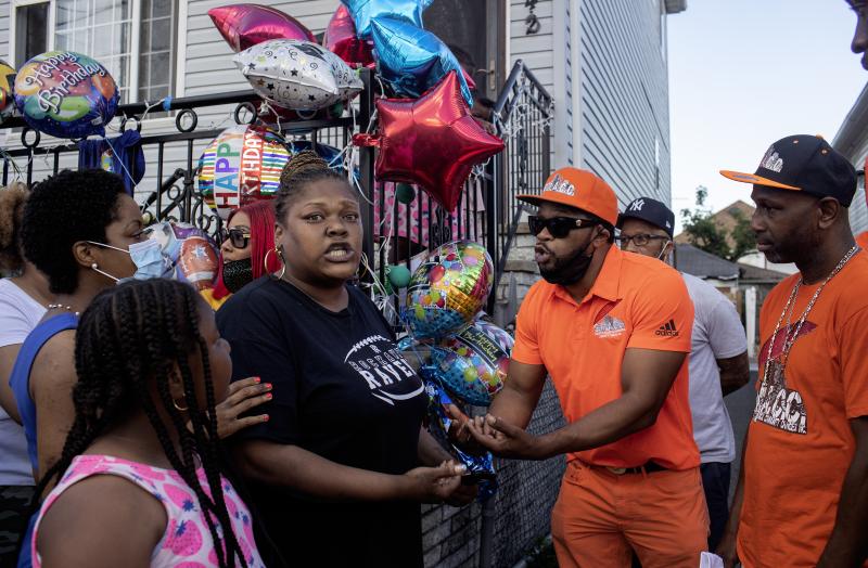 Shanduke McPhatter, a non-violence activist, talks to a woman who recently lost a relative to gun violence. The peace vigil took place on the block where 10-year-old Justin Wallace was shot to death. Shanduke McPhatter, a non-violence activist, talks to a woman who recently lost a relative to gun violence. The peace vigil took place on the block where 10-year-old Justin Wallace was shot to death.