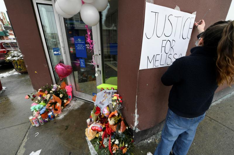 Karla Chavez, of the social activist group Chiactivists, puts up a sign at a memorial for 8-year-old Melissa Ortega in Chicago on Jan, 24. Ortega was walking with her mother in Chicago's Little Village neighborhood on Jan. 22 when she was struck by stray Karla Chavez, of the social activist group Chiactivists, puts up a sign at a memorial for 8-year-old Melissa Ortega in Chicago on Jan, 24. Ortega was walking with her mother in Chicago's Little Village neighborhood on Jan. 22 when she was struck by stray