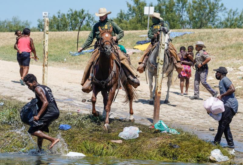 United States Border Patrol agents on horseback try to stop Haitian migrants from entering an encampment on the banks of the Río Grande near the Acuña Del Río International Bridge in Del Río, Texas on Sept. 19. United States Border Patrol agents on horseback try to stop Haitian migrants from entering an encampment on the banks of the Río Grande near the Acuña Del Río International Bridge in Del Río, Texas on Sept. 19.