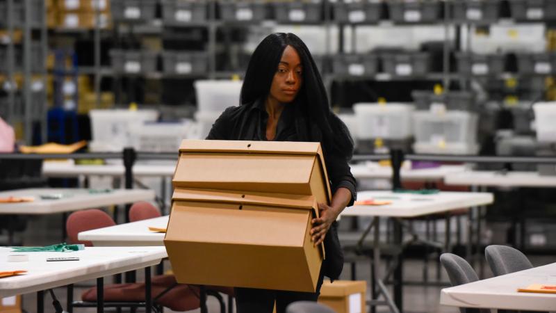 A woman sets up tables for hand-counting ballots in Palm Beach County on Thursday. A woman sets up tables for hand-counting ballots in Palm Beach County on Thursday.