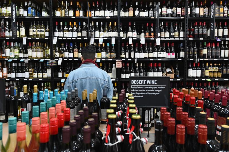 A patron stands in front of a shelf full of wine bottles at a liquor story in the Brooklyn borough of New York City on March 20. A patron stands in front of a shelf full of wine bottles at a liquor story in the Brooklyn borough of New York City on March 20.