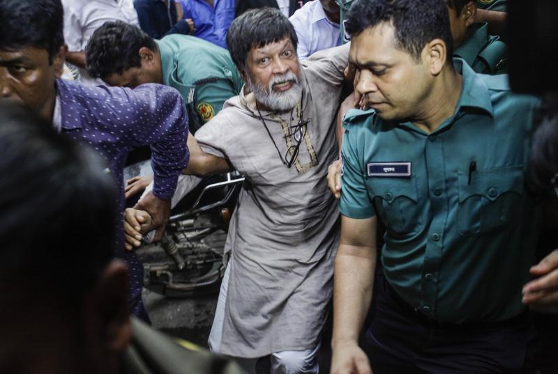 Shahidul Alam, surrounded by police, arrives at a Dhaka court on Aug. 6. Nobel laureates and human rights groups have called for his release. Shahidul Alam, surrounded by police, arrives at a Dhaka court on Aug. 6. Nobel laureates and human rights groups have called for his release.