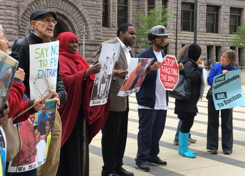 Protesters gathered outside the federal courthouse in Minneapolis where three young Somali-Americans are on trial for allegedly planning to go to Syria to join the Islamic State. The demonstrators say the FBI and local law enforcement is targeting and ent Protesters gathered outside the federal courthouse in Minneapolis where three young Somali-Americans are on trial for allegedly planning to go to Syria to join the Islamic State. The demonstrators say the FBI and local law enforcement is targeting and ent