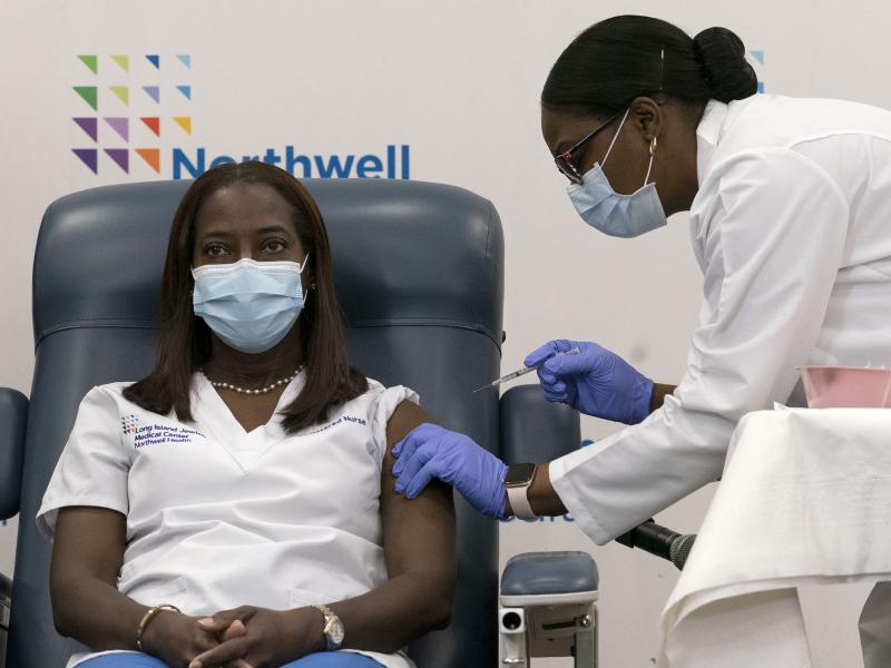 Sandra Lindsay (left) a nurse at Long Island Jewish Medical Center, is inoculated with the Pfizer-BioNTech COVID-19 vaccine by Dr. Michelle Chester on Monday in New York. Sandra Lindsay (left) a nurse at Long Island Jewish Medical Center, is inoculated with the Pfizer-BioNTech COVID-19 vaccine by Dr. Michelle Chester on Monday in New York.