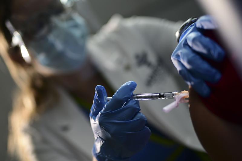 Nurse Melissa Valentin applies the Pfizer-BioNTech COVID-19 vaccine to a health worker at the Ashford Presbyterian Community Hospital in San Juan, Puerto Rico, Tuesday. The vaccine was granted emergency use authorization last week. Nurse Melissa Valentin applies the Pfizer-BioNTech COVID-19 vaccine to a health worker at the Ashford Presbyterian Community Hospital in San Juan, Puerto Rico, Tuesday. The vaccine was granted emergency use authorization last week.