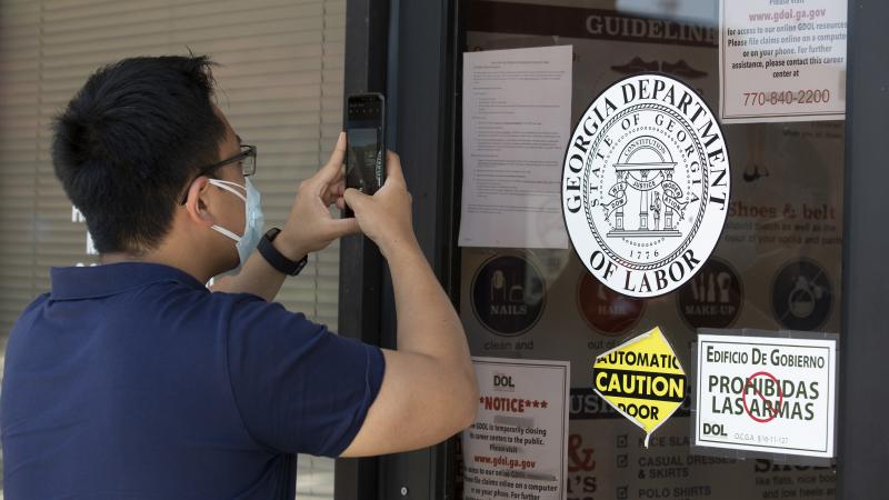 A man copies phone numbers posted on the locked doors of a Georgia Department of Labor office in in Norcross, Ga. Millennials are facing the second — or even third — economic downturn of their adult lives. A man copies phone numbers posted on the locked doors of a Georgia Department of Labor office in in Norcross, Ga. Millennials are facing the second — or even third — economic downturn of their adult lives.