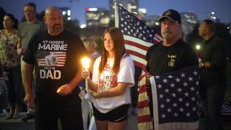 Sydney Robison, center, looks on during a vigil for U.S. Marines Staff Sgt. Taylor Hoover Sunday in Salt Lake City. Hoover was among the 13 U.S. troops killed in a suicide bombing at Kabul airport. Sydney Robison, center, looks on during a vigil for U.S. Marines Staff Sgt. Taylor Hoover Sunday in Salt Lake City. Hoover was among the 13 U.S. troops killed in a suicide bombing at Kabul airport.