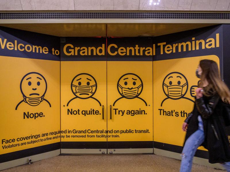 A woman walks past posters explaining mask requirements at Grand Central Terminal train station in New York City on Wednesday. Rules requiring masks on transit are unchanged by the Centers for Disease Control and Prevention's updated mask guidance for ful A woman walks past posters explaining mask requirements at Grand Central Terminal train station in New York City on Wednesday. Rules requiring masks on transit are unchanged by the Centers for Disease Control and Prevention's updated mask guidance for ful