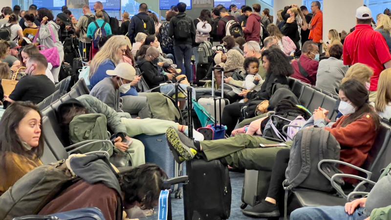 Dr. Anthony Fauci, chief medical adviser to President Biden, cites the U.S. vaccination program and previous widespread transmission of the coronavirus as reasons why the U.S. is not now under pandemic conditions. Here, travelers wait at Miami Internation Dr. Anthony Fauci, chief medical adviser to President Biden, cites the U.S. vaccination program and previous widespread transmission of the coronavirus as reasons why the U.S. is not now under pandemic conditions. Here, travelers wait at Miami Internation