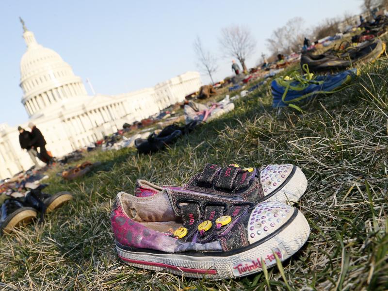 Thousands of empty empty pairs of shoes for every child killed by guns in the U.S. since Sandy Hook cover the southeast lawn of U.S. Capitol on March 13, 2018, in Washington, D.C. Thousands of empty empty pairs of shoes for every child killed by guns in the U.S. since Sandy Hook cover the southeast lawn of U.S. Capitol on March 13, 2018, in Washington, D.C.