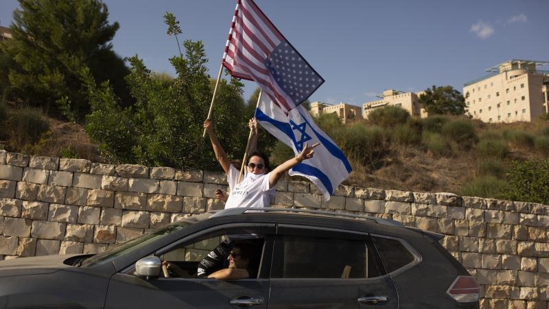 Supporters of President Trump wave U.S. and Israeli flags from a car last week headed for a rally outside the U.S. Embassy in Jerusalem. Supporters of President Trump wave U.S. and Israeli flags from a car last week headed for a rally outside the U.S. Embassy in Jerusalem.