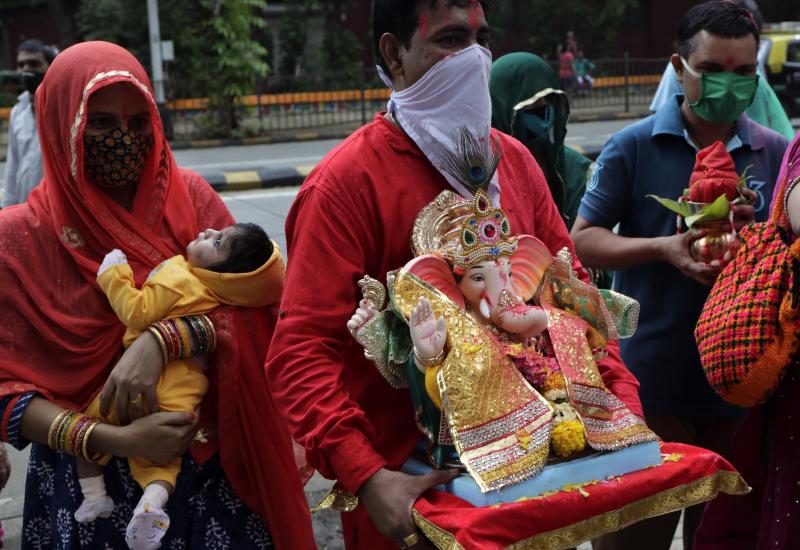 Devotees prepare to immerse in an artificial pond an idol of elephant-headed Hindu god Ganesh in Mumbai, India, Aug. 23. India's coronavirus caseload topped 3 million that day, with the country leading the world in new daily infections. Devotees prepare to immerse in an artificial pond an idol of elephant-headed Hindu god Ganesh in Mumbai, India, Aug. 23. India's coronavirus caseload topped 3 million that day, with the country leading the world in new daily infections.