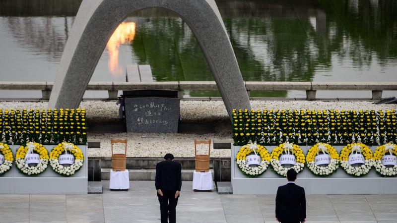 Japanese Prime Minister Shinzo Abe bows Thursday in front of a memorial to people who were killed in the 1945 atomic bombing of Hiroshima. Japanese Prime Minister Shinzo Abe bows Thursday in front of a memorial to people who were killed in the 1945 atomic bombing of Hiroshima.