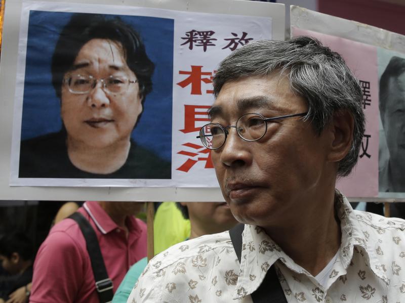 Freed Hong Kong bookseller Lam Wing-kee stands next to a placard with a picture of bookseller Gui Minhai, in front of his book store in Hong Kong in June 2016. Freed Hong Kong bookseller Lam Wing-kee stands next to a placard with a picture of bookseller Gui Minhai, in front of his book store in Hong Kong in June 2016.