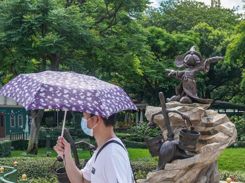 A visitor wearing a protective mask walks past a statue of Mickey Mouse at the Hong Kong Disneyland Resort on June 18, the day it initially reopened. The amusement park will close again on Wednesday. A visitor wearing a protective mask walks past a statue of Mickey Mouse at the Hong Kong Disneyland Resort on June 18, the day it initially reopened. The amusement park will close again on Wednesday.