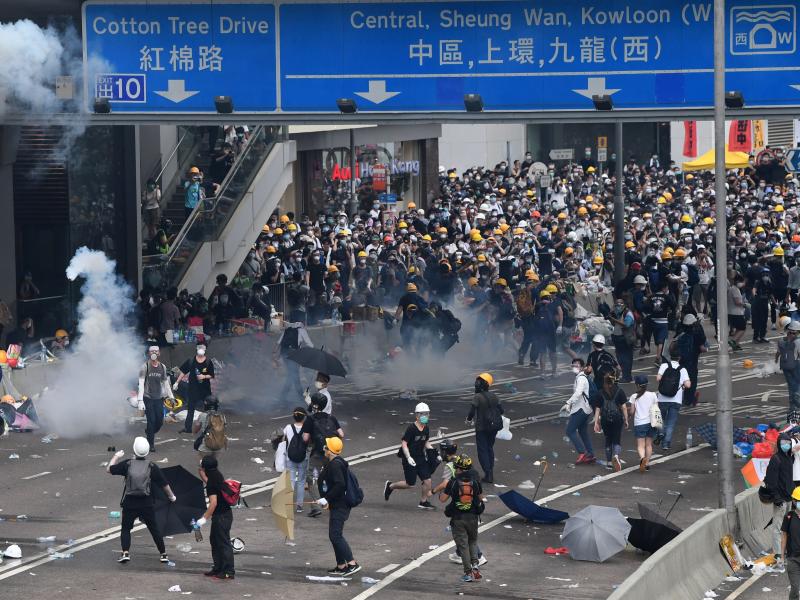 Protesters react after police fired tear gas during a rally against a controversial extradition law proposal outside the government headquarters in Hong Kong on Wednesday. Protesters react after police fired tear gas during a rally against a controversial extradition law proposal outside the government headquarters in Hong Kong on Wednesday.
