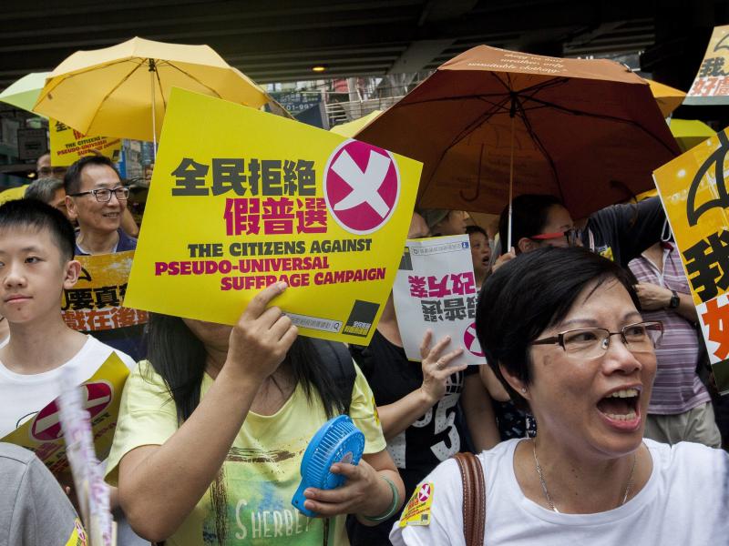 Supporters of free and open elections in Hong Kong march through the city streets ahead of a crucial vote on political reform in the city's Legislative Council. Supporters of free and open elections in Hong Kong march through the city streets ahead of a crucial vote on political reform in the city's Legislative Council.