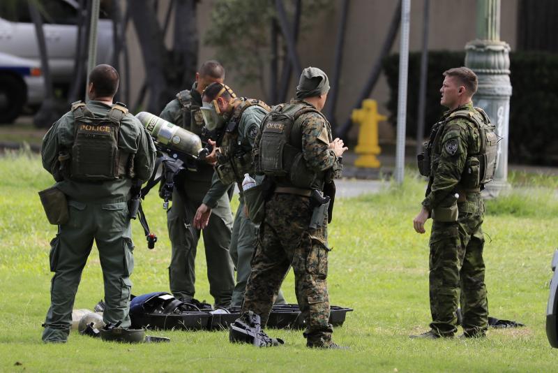 Honolulu police gather near the scene of a shooting near Diamond Head State Monument on Sunday. Honolulu police gather near the scene of a shooting near Diamond Head State Monument on Sunday.
