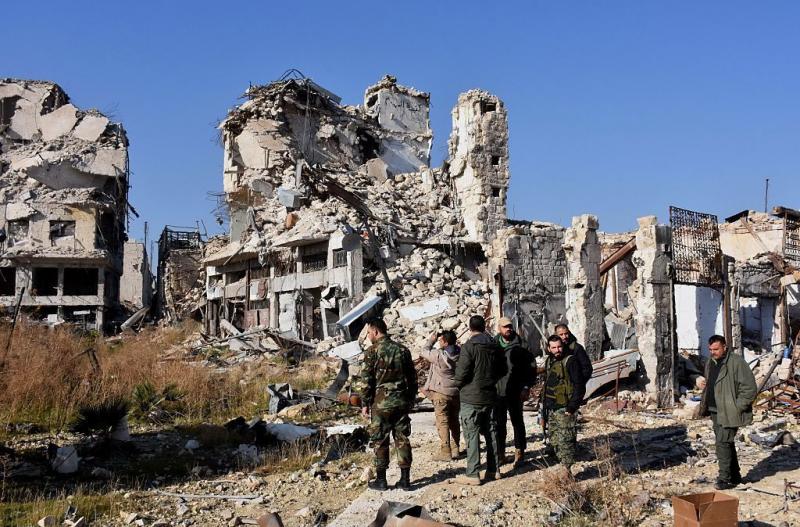 Syrian pro-government forces stand amidst the rubble in old Aleppo's Jdeideh neighborhood on Friday. Syrian pro-government forces stand amidst the rubble in old Aleppo's Jdeideh neighborhood on Friday.