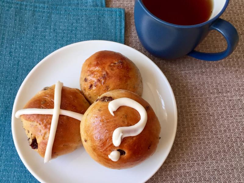 Decorating Easter buns with a variety of symbols is an inclusive way to share holiday food. Decorating Easter buns with a variety of symbols is an inclusive way to share holiday food.