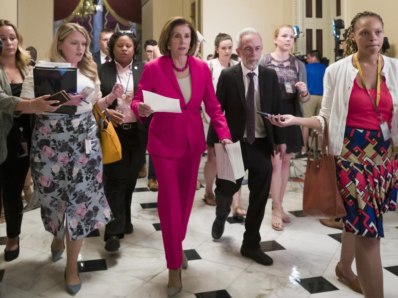 Speaker Nancy Pelosi of California walks to the House floor Thursday. In a letter to Democratic lawmakers she announced the House would "reluctantly" pass a Senate version of an emergency immigration aid package. Speaker Nancy Pelosi of California walks to the House floor Thursday. In a letter to Democratic lawmakers she announced the House would "reluctantly" pass a Senate version of an emergency immigration aid package.