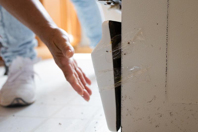 The bottom of María Lara's oven is broken and full of mice feces. It is held in place with packing tape. The bottom of María Lara's oven is broken and full of mice feces. It is held in place with packing tape.