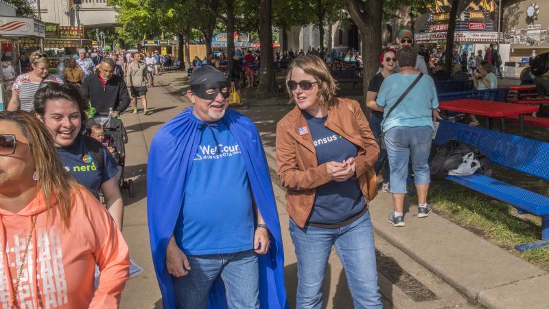 Minnesota's state demographer, Susan Brower (center), walks with Dean Goldberg, donning a blue cape and black mask as "Census Man," through the 2019 Minnesota State Fair in St. Paul, Minn., to encourage residents to participate in the national head count. Minnesota's state demographer, Susan Brower (center), walks with Dean Goldberg, donning a blue cape and black mask as "Census Man," through the 2019 Minnesota State Fair in St. Paul, Minn., to encourage residents to participate in the national head count.