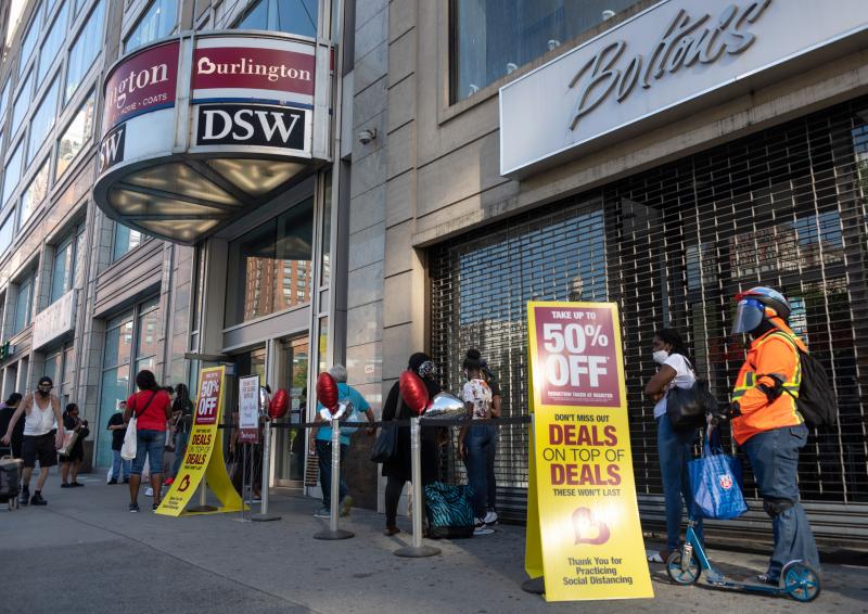 Shoppers line up near sale signs at a Burlington store in New York in June. Shoppers line up near sale signs at a Burlington store in New York in June.