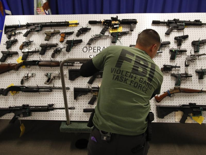 An FBI agent displays seized firearms from a gang investigation. Digital facial recognition helped the bureau track down an MS-13 member wanted in connection with murder. An FBI agent displays seized firearms from a gang investigation. Digital facial recognition helped the bureau track down an MS-13 member wanted in connection with murder.