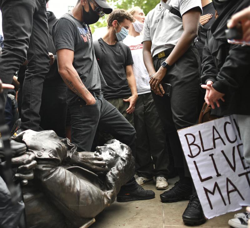 Protesters pull down a statue of slave trader Edward Colston during a Black Lives Matter protest on College Green, Bristol, England, on Sunday. The protest grew in response to the recent killing of George Floyd by police officers in Minneapolis that spark Protesters pull down a statue of slave trader Edward Colston during a Black Lives Matter protest on College Green, Bristol, England, on Sunday. The protest grew in response to the recent killing of George Floyd by police officers in Minneapolis that spark