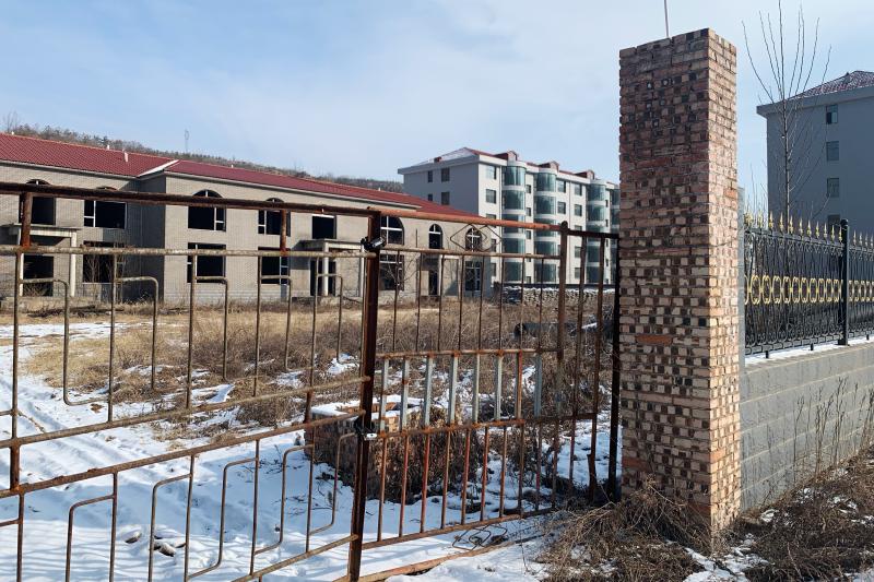 According to Zhang Zhixiong's family, Juxin Mining Co. paid for several village infrastructure projects, including building new apartment complexes for local residents. The buildings were weeks away from completion before Zhang was arrested and now stand According to Zhang Zhixiong's family, Juxin Mining Co. paid for several village infrastructure projects, including building new apartment complexes for local residents. The buildings were weeks away from completion before Zhang was arrested and now stand