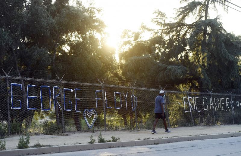 A walker passes the names of George Floyd and Eric Garner spelled out in fabric at the Say Their Names: Silver Lake Memorial on June 9 in Los Angeles. There has been a recent push for a nationwide ban on police chokeholds. A walker passes the names of George Floyd and Eric Garner spelled out in fabric at the Say Their Names: Silver Lake Memorial on June 9 in Los Angeles. There has been a recent push for a nationwide ban on police chokeholds.