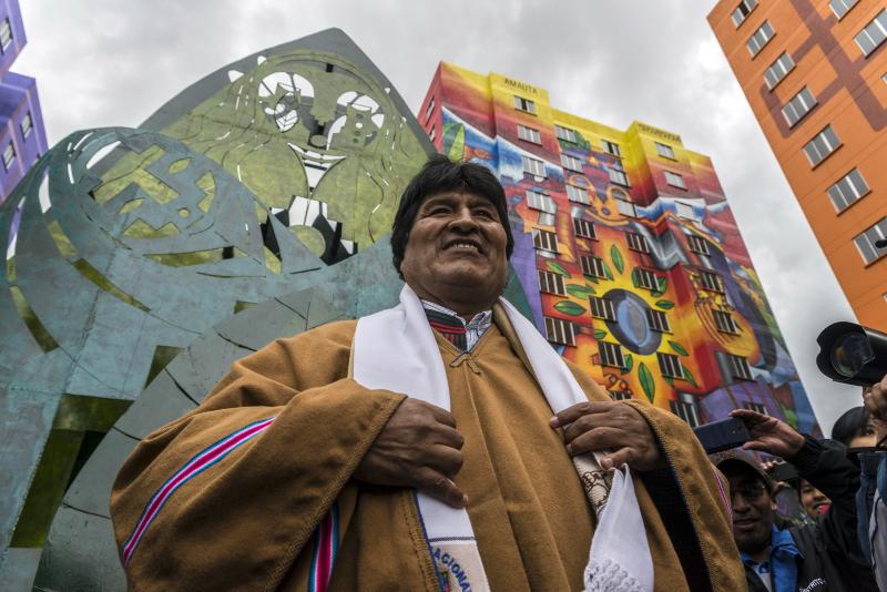 President Evo Morales at the inauguration of new buildings in a housing project in 2016. The indigenous Aymara artist Roberto Mamani Mamani painted murals over a building facade. President Evo Morales at the inauguration of new buildings in a housing project in 2016. The indigenous Aymara artist Roberto Mamani Mamani painted murals over a building facade.
