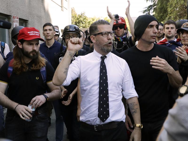 In this 2017 photo, Gavin McInnes (center), founder of the far-right extremist group known as the Proud Boys, is surrounded by supporters after speaking at a rally in Berkeley, Calif. McInnes told NPR that the group is made up of "funny dudes, not Nazis." In this 2017 photo, Gavin McInnes (center), founder of the far-right extremist group known as the Proud Boys, is surrounded by supporters after speaking at a rally in Berkeley, Calif. McInnes told NPR that the group is made up of "funny dudes, not Nazis."