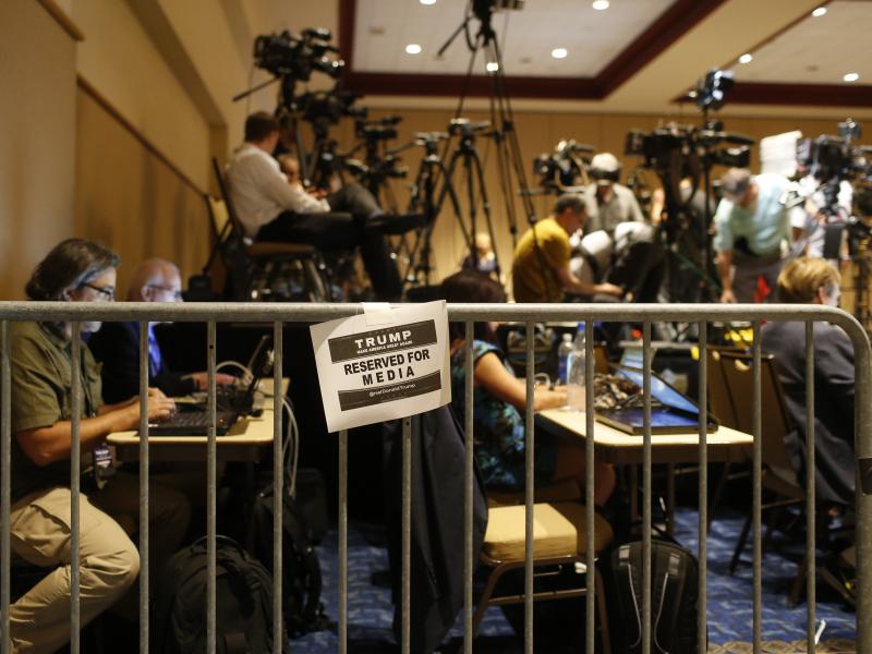 Journalists work in the Trump campaign's designated media pen as they wait for the candidate to arrive at a town hall meeting on March 14 in Tampa, Fla. Foreign journalists covering the campaign say gaining official access to Trump events has been more ch Journalists work in the Trump campaign's designated media pen as they wait for the candidate to arrive at a town hall meeting on March 14 in Tampa, Fla. Foreign journalists covering the campaign say gaining official access to Trump events has been more ch
