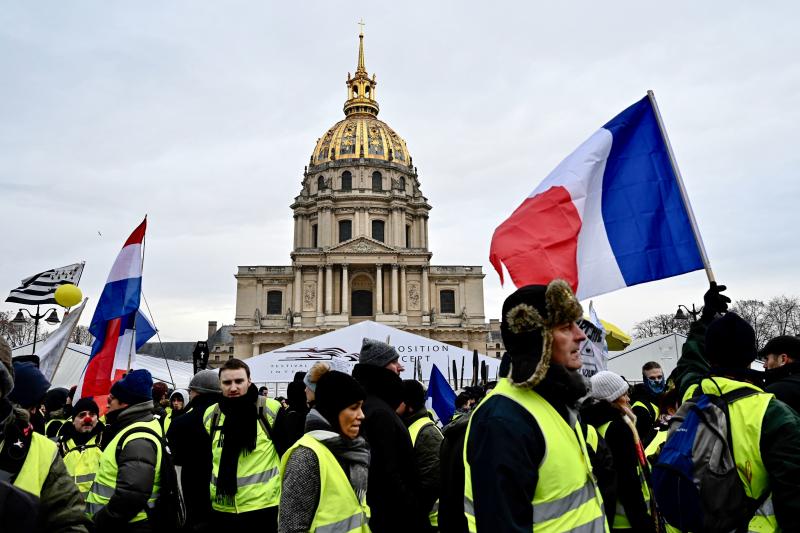 Protesters take part in an antigovernment yellow vest demonstration in front of the Hôtel National des Invalides in Paris early in January. Protesters take part in an antigovernment yellow vest demonstration in front of the Hôtel National des Invalides in Paris early in January.