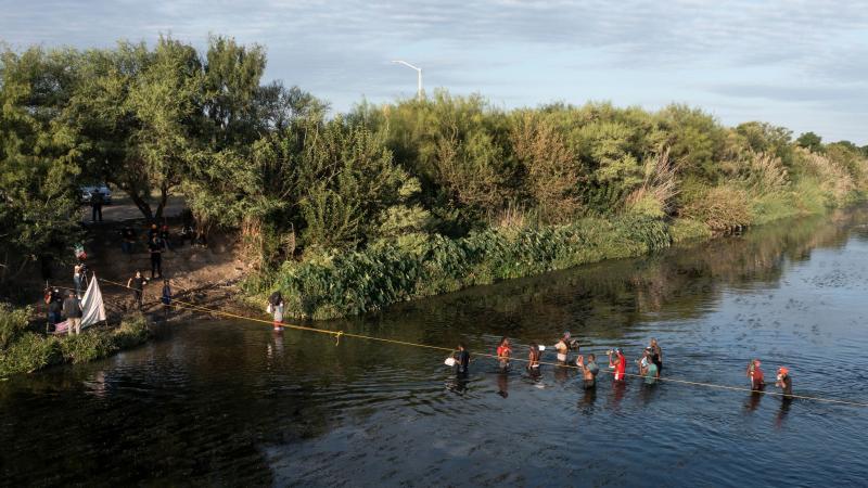 Haitian migrants cross the Rio Grande on Wednesday to get food and water in Mexico, as seen from Ciudad Acuña, Mexico. The U.S. is allowing some migrants to enter the country and sending others back to Haiti. Haitian migrants cross the Rio Grande on Wednesday to get food and water in Mexico, as seen from Ciudad Acuña, Mexico. The U.S. is allowing some migrants to enter the country and sending others back to Haiti.