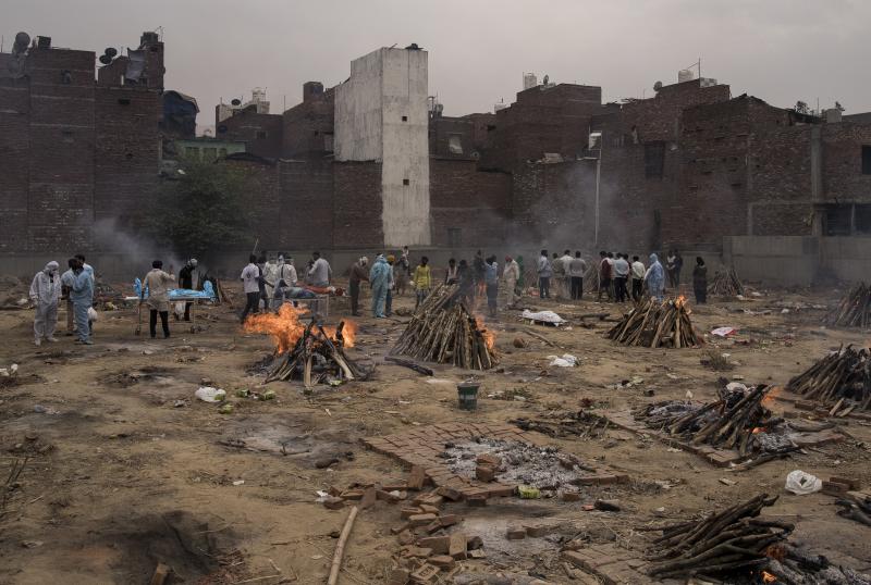 Funeral pyres for patients who died of COVID-19 are seen burning this week at a makeshift crematorium in New Delhi. Funeral pyres for patients who died of COVID-19 are seen burning this week at a makeshift crematorium in New Delhi.